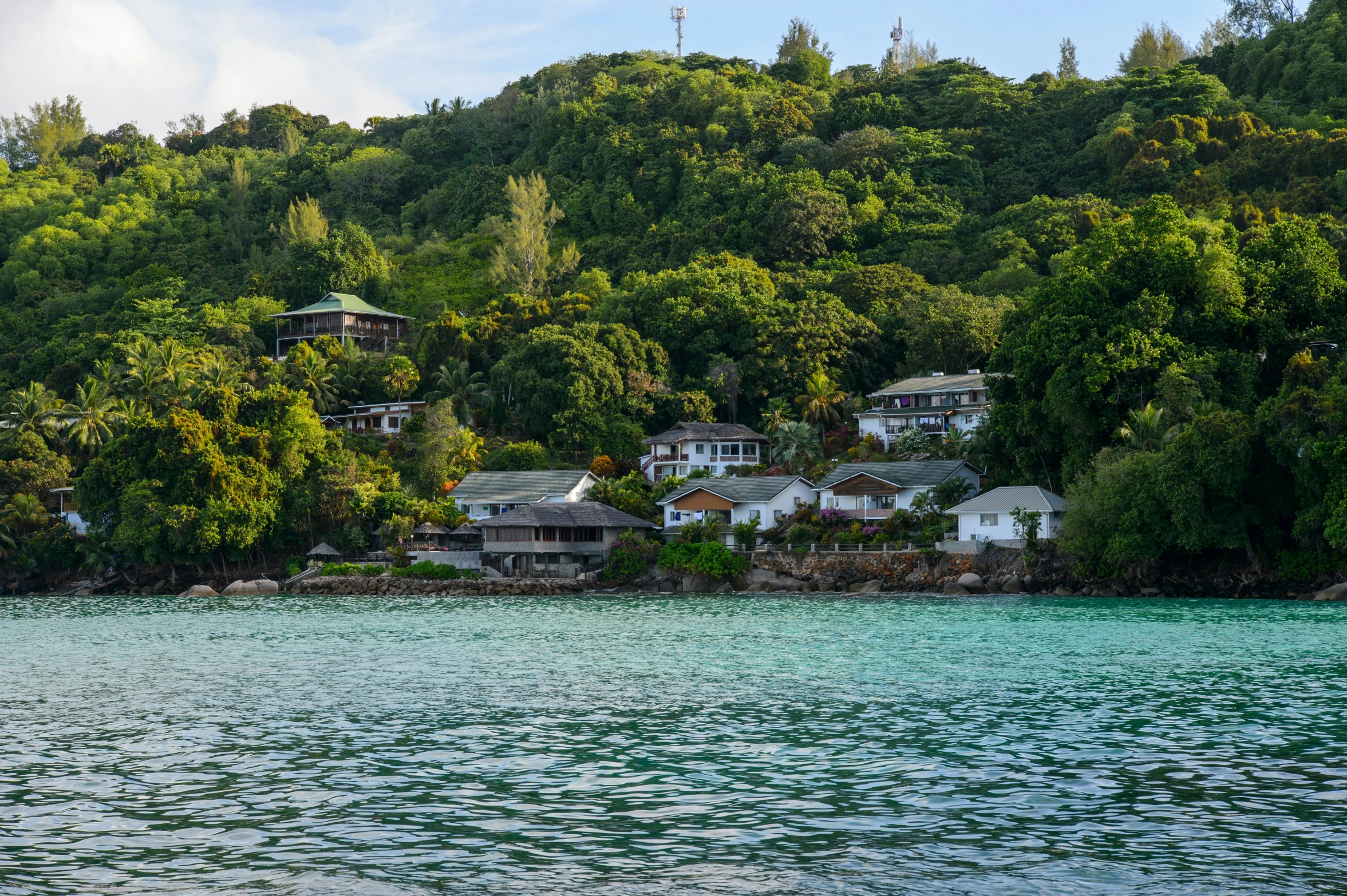 a view of houses on the side of a hill from a boat