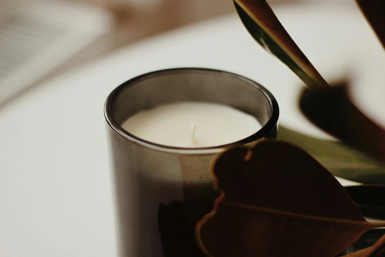 close up s of an un - opened cup containing the contents of a candle