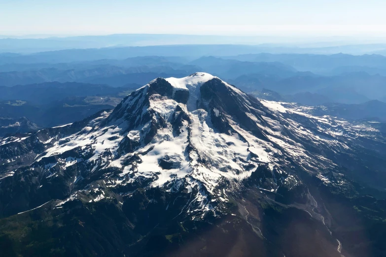 a mountain with a white snow covered top and some trees