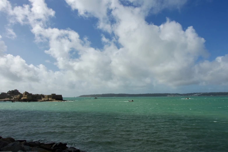 a body of water with some boats in the distance