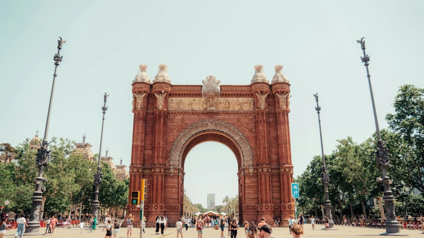 a gated entrance to the park next to many people