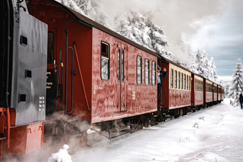 a small train on a track in the snow