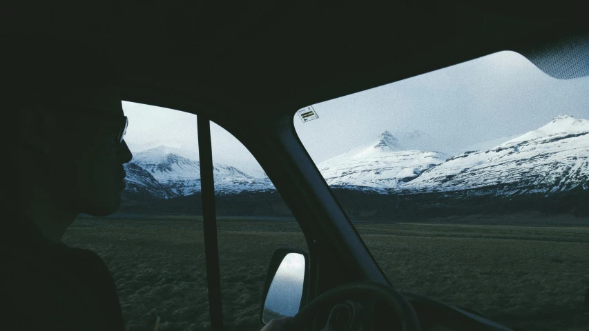 view from the driver seat while driving towards mountains