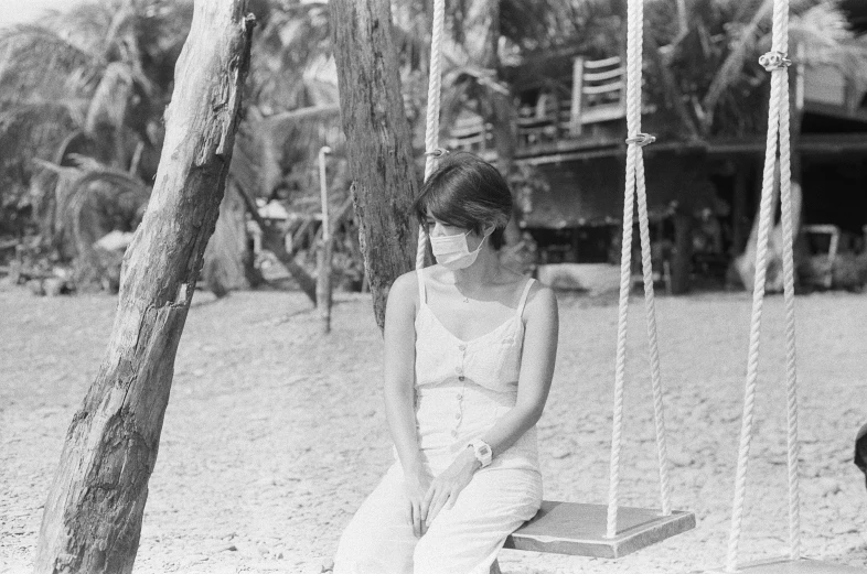 an old fashion po of a girl on a swing