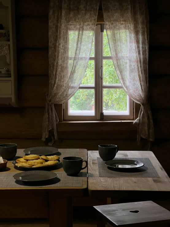 a dining table set up for dinner and food