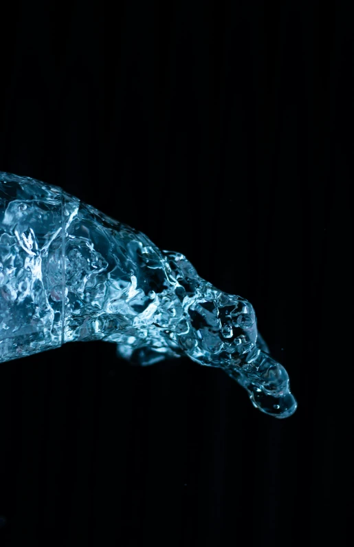 some ice on a black background and it looks like the end of a spoon is broken