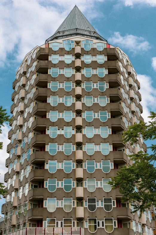 a large multi story building with balconies in the windows