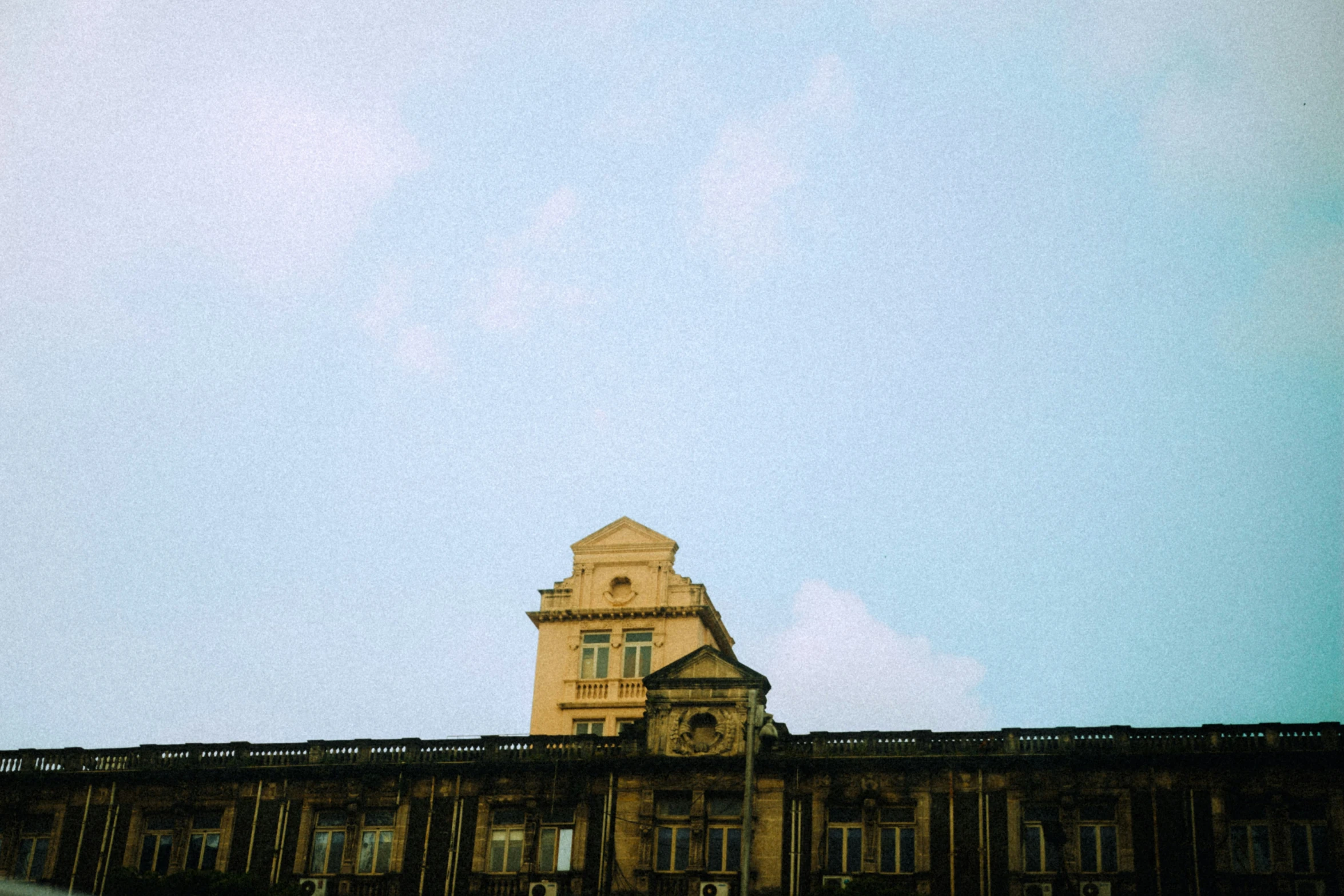 an old building with a clock on the roof