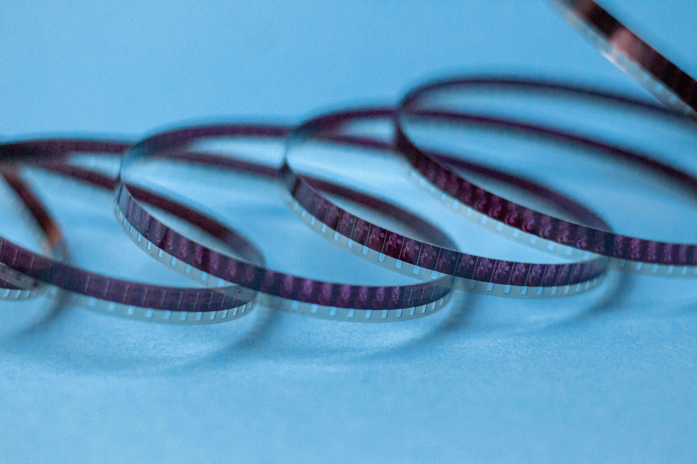 four looped pieces of purple tape on a blue background