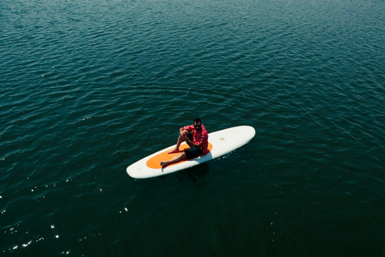 an overhead view of a person on a surf board