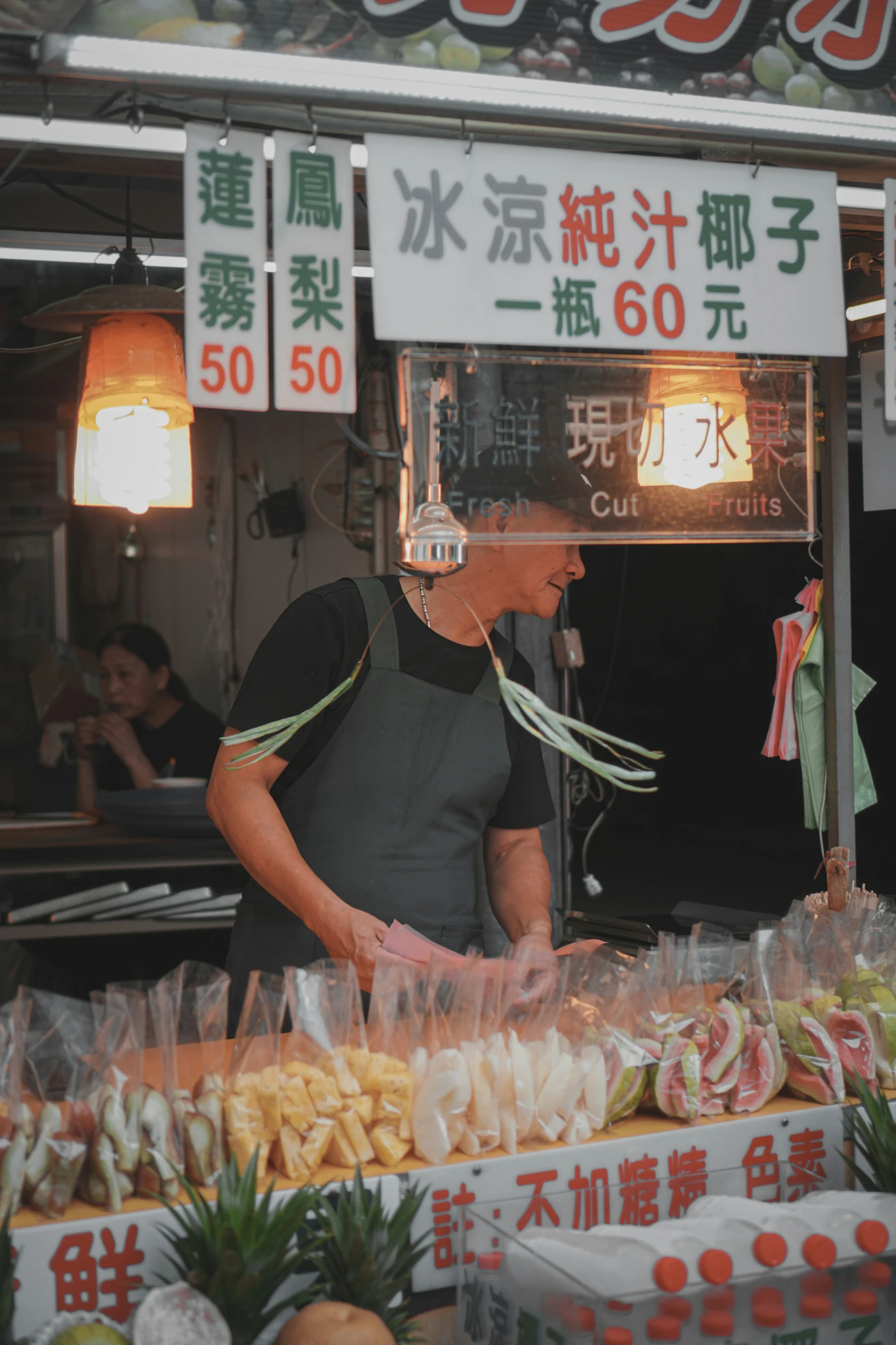 a person selling food in an asian marketplace