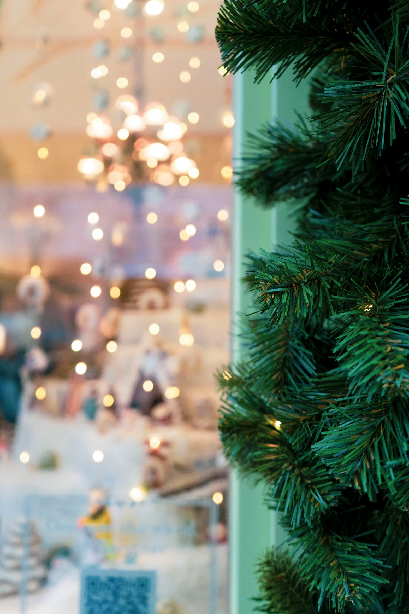 a christmas tree with decorations, lights and a building in the background