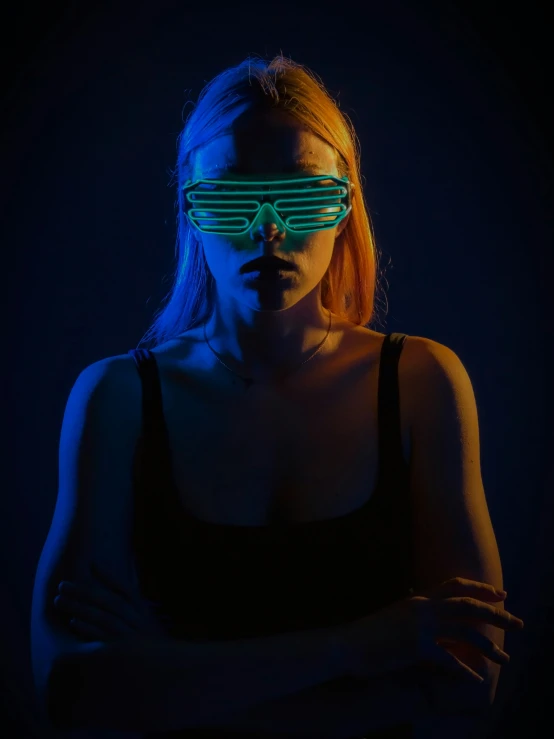 a woman wearing sunglasses in the dark