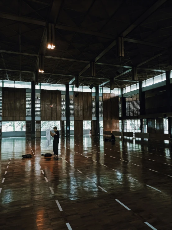 a person standing in a dark room with the floor exposed