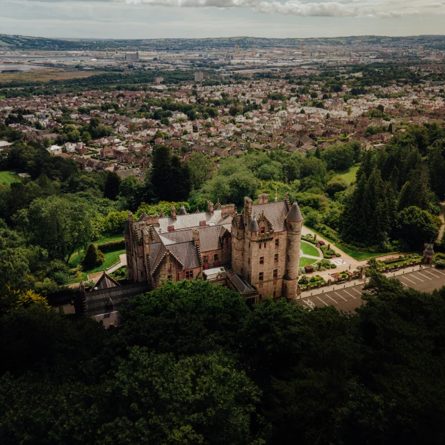 this is an aerial view of a castle in a lush area