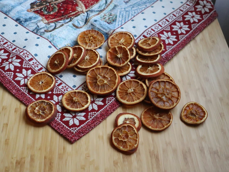 peeled tangerines on a quilted tablecloth and wooden table