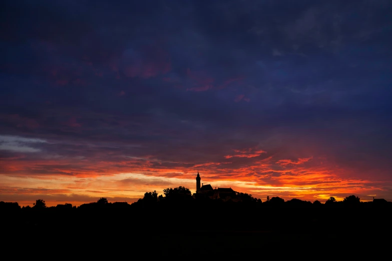 a beautiful sunset in front of an empty city with trees