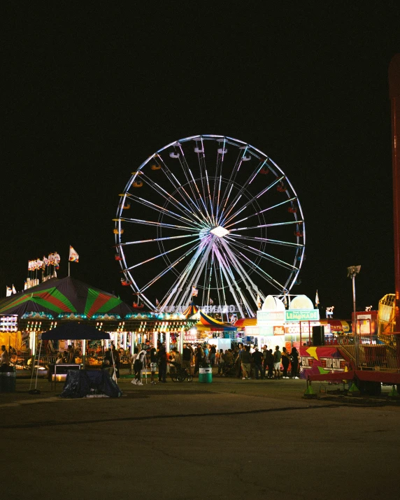 amut ride and ferris wheel lit up on the dark