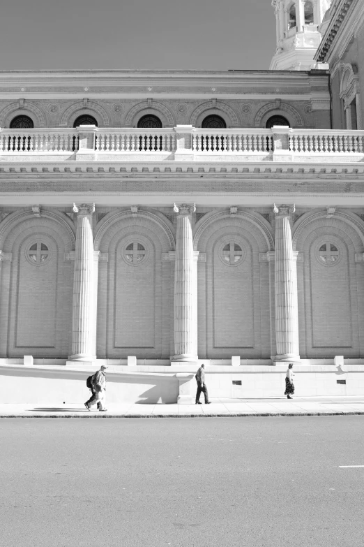 two people are walking down a city street