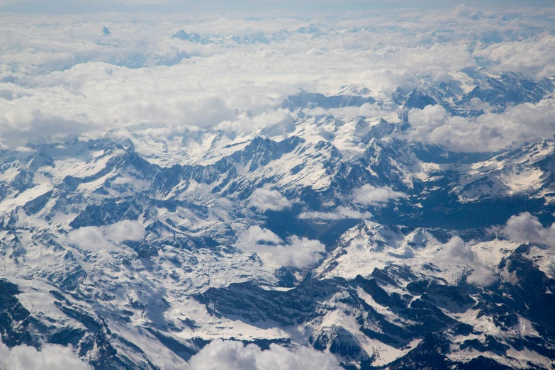 a view of snow covered mountains from an airplane