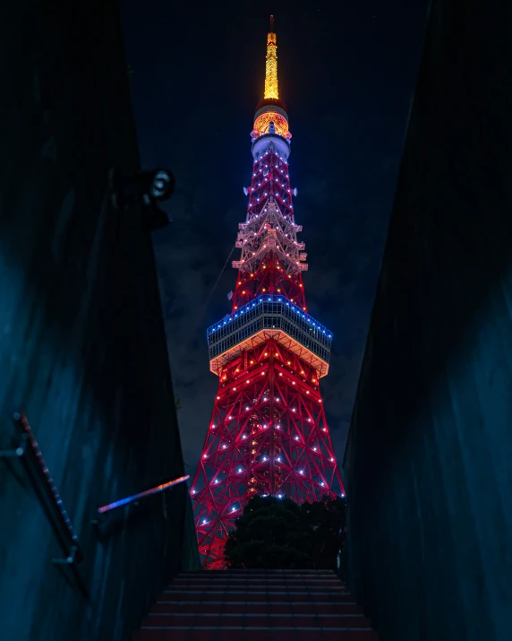 there is a very tall building with a colorful top