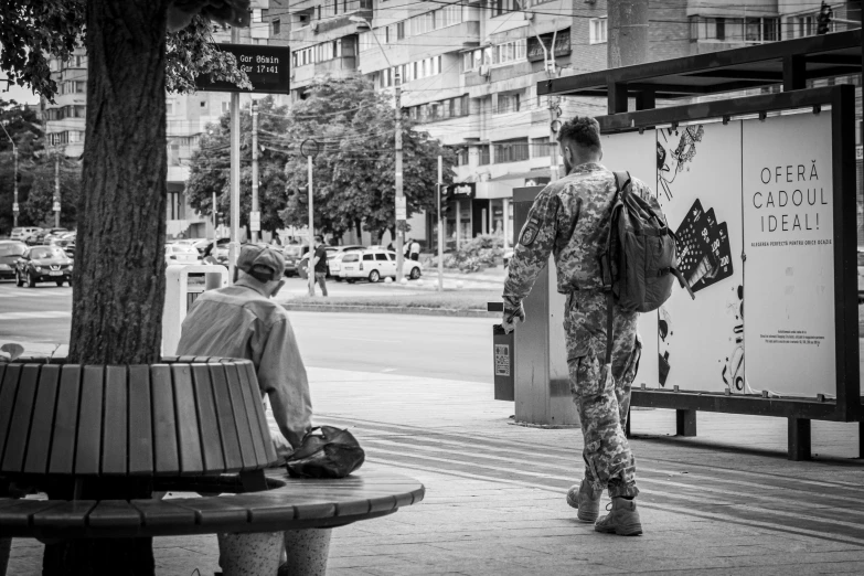 the man in the uniform is sitting on a bench