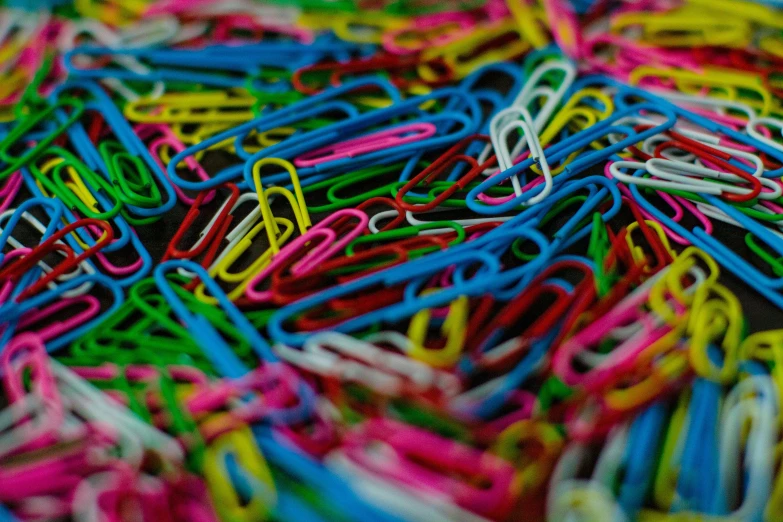 a very big pile of colorful pins and scissors