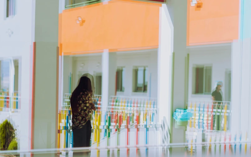 a woman standing near a bunch of colorful toothpaste