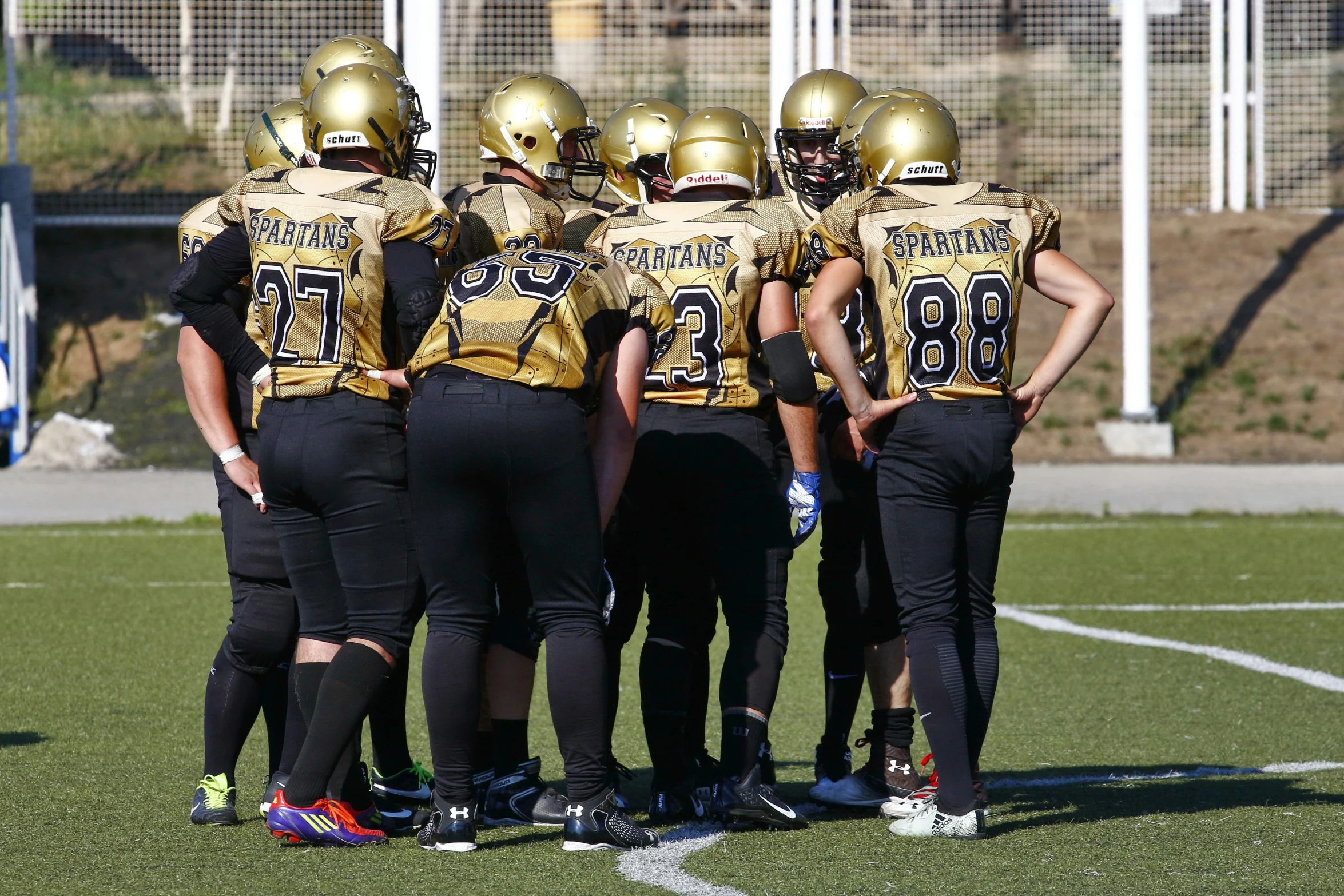 a group of football players standing on the field
