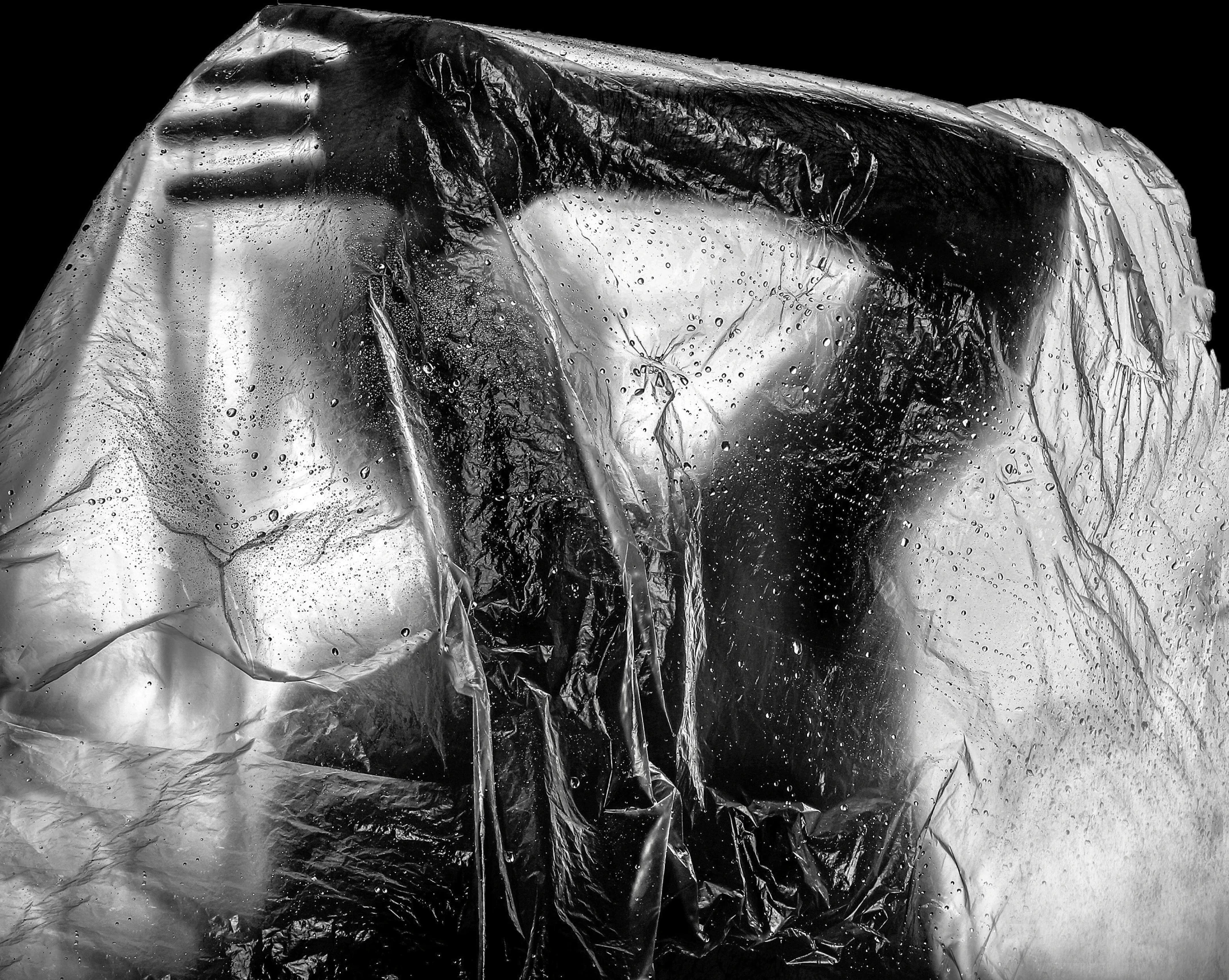 the side view of a black bag with rain drops on it