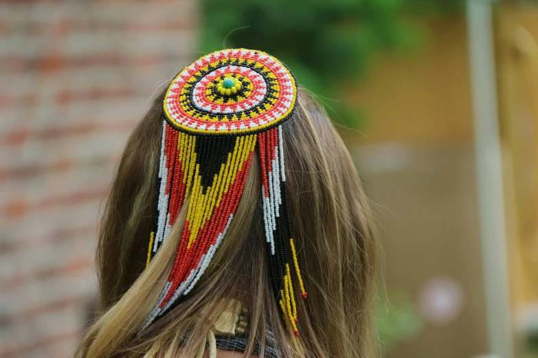 a woman wearing a native headdress that is multicolored