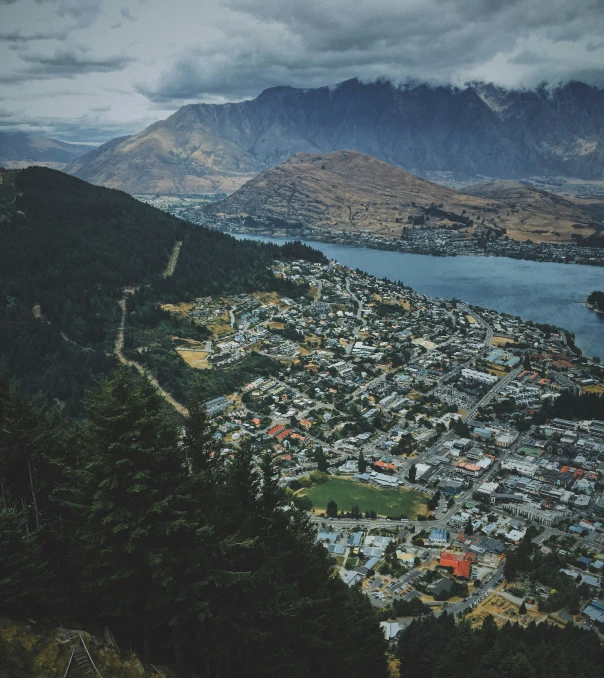 a city by the water with mountains in the background