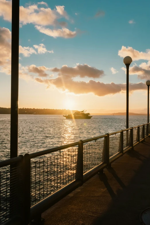 boats are floating in the water at sunset