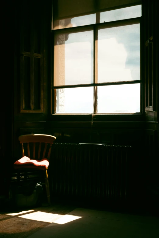 a red chair sitting next to a window