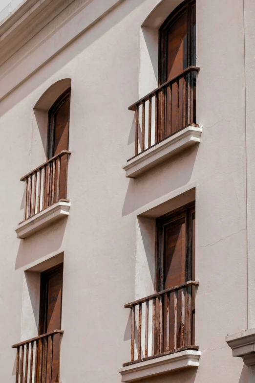 a picture of two story apartment building with lots of balconies