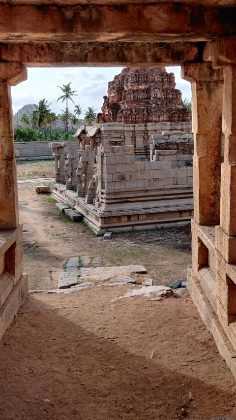 a few stone structures in the middle of a dirt field