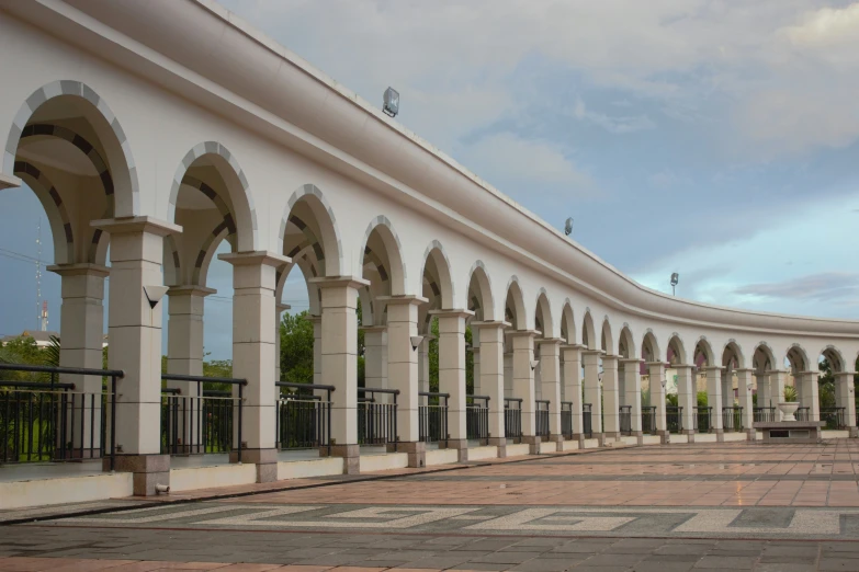 rows of arched doorways are lined against white stucco