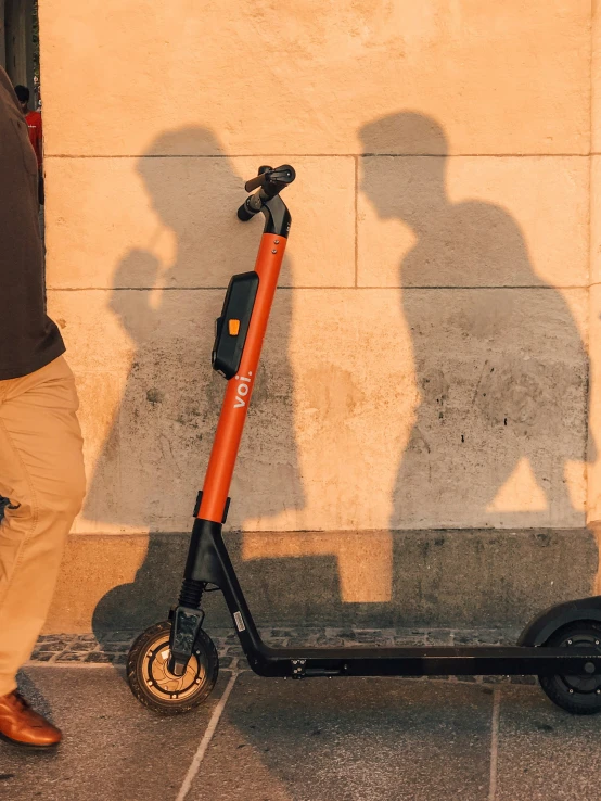 there is a shadow from a person on a scooter