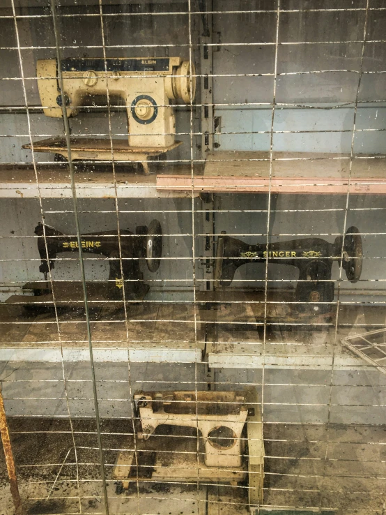 a room with some old sewing machines and window blinds