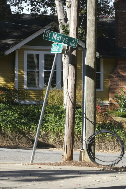 a street sign that is leaning on a pole