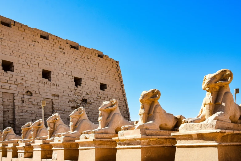 this is the face of a stone building with statues of animals in front