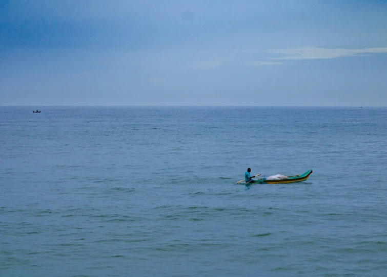 a man riding in the back of a canoe