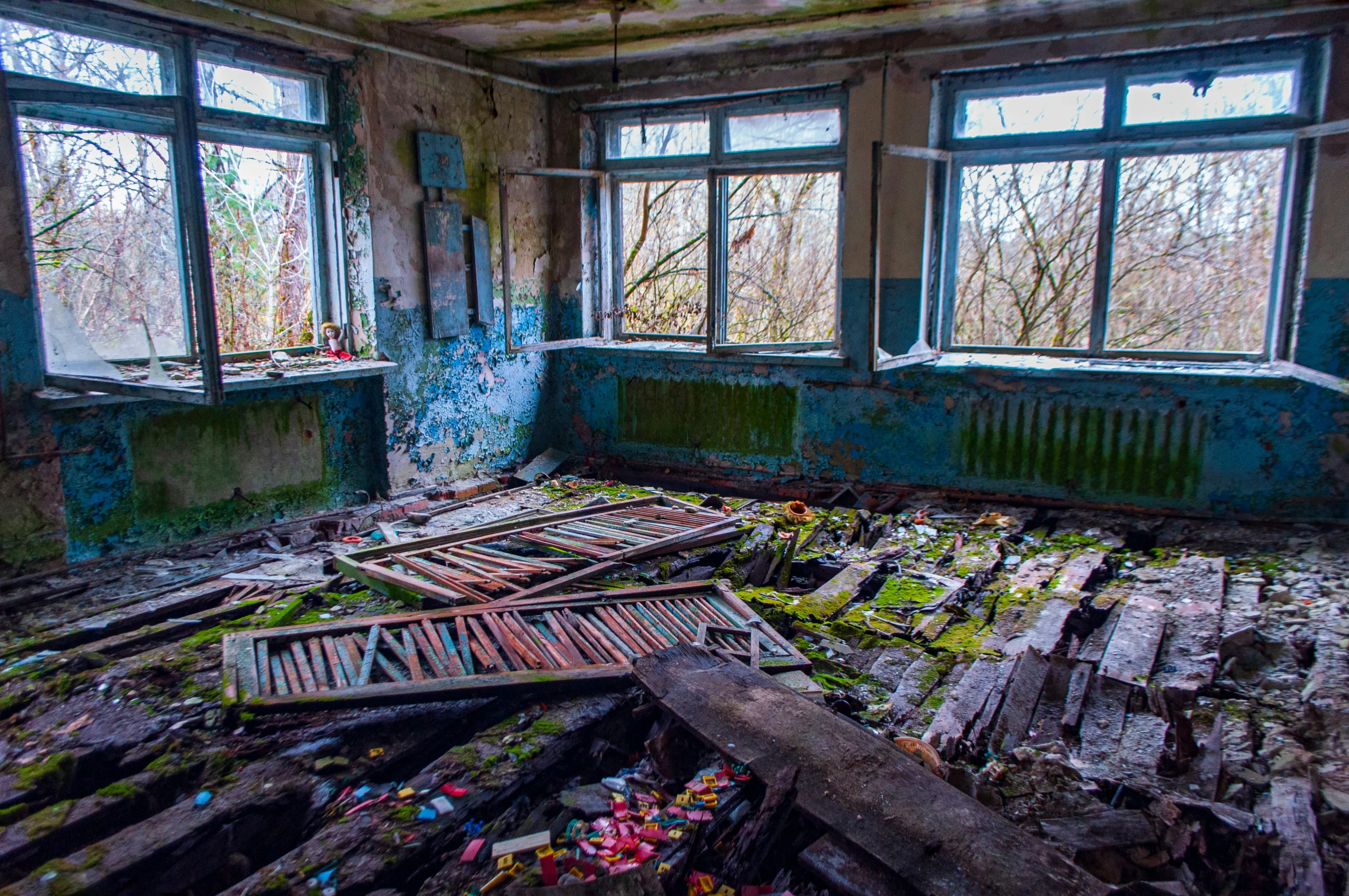 an old run down building with peeling paint on the walls and windows