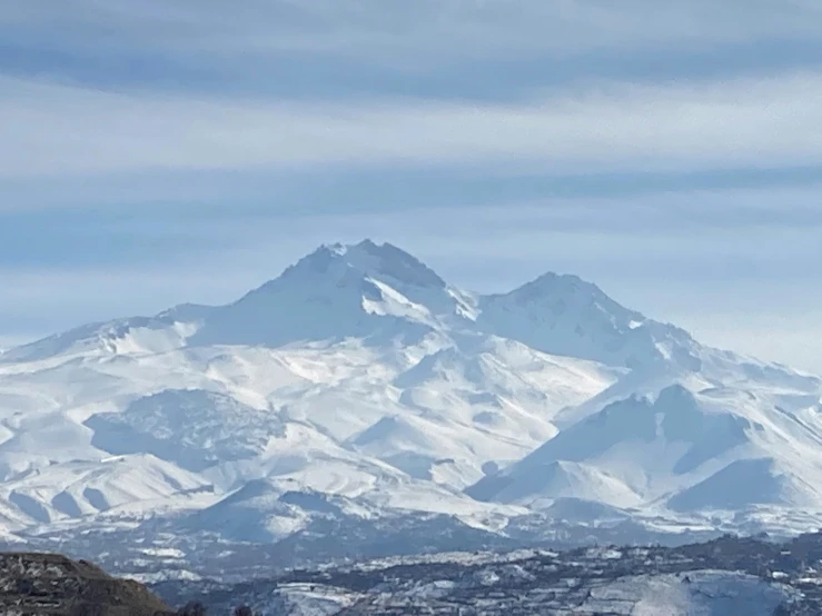 a snowy mountainside with a town below it