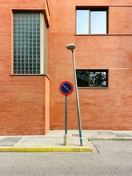 a sign post next to a tall brick building