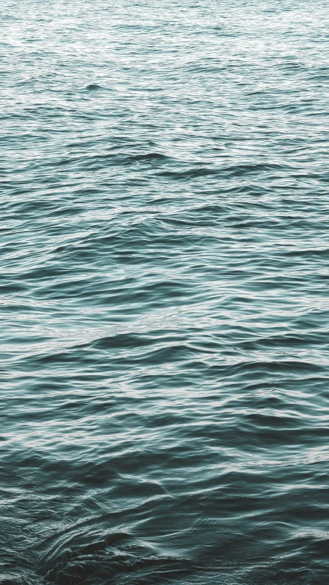 someone riding a boat on a large body of water