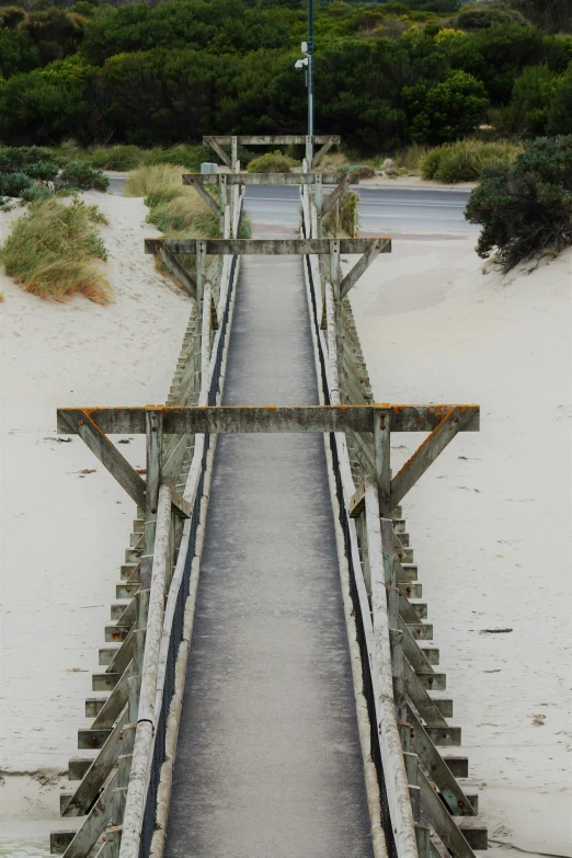 a long path with railings and a clock atop top