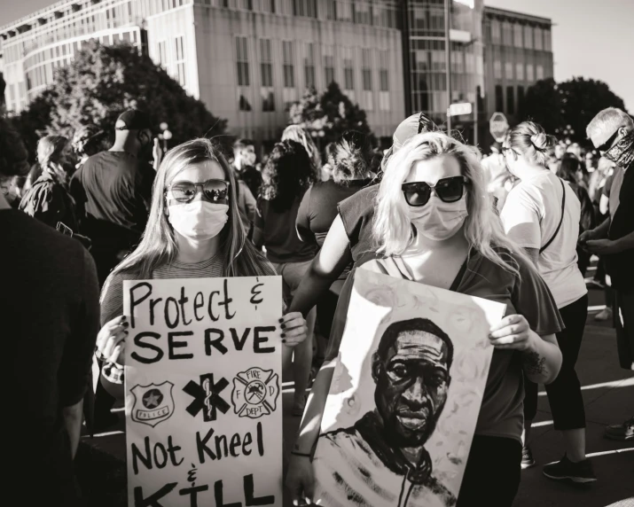 several people standing outside holding up signs