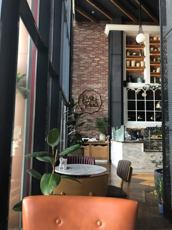 the outside of a bar with leather chairs