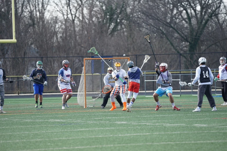 lacrosse teams running and playing on an artificial soccer field